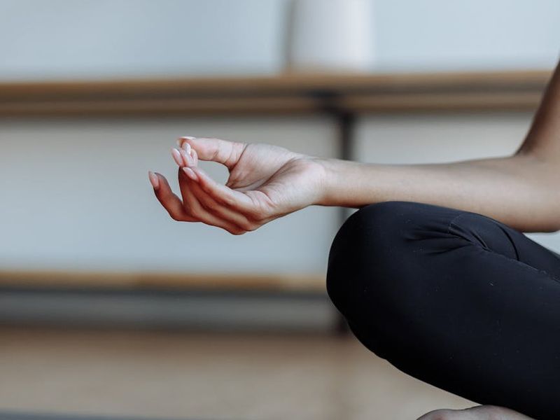Close up of yoga practitioner hands in a mudra.