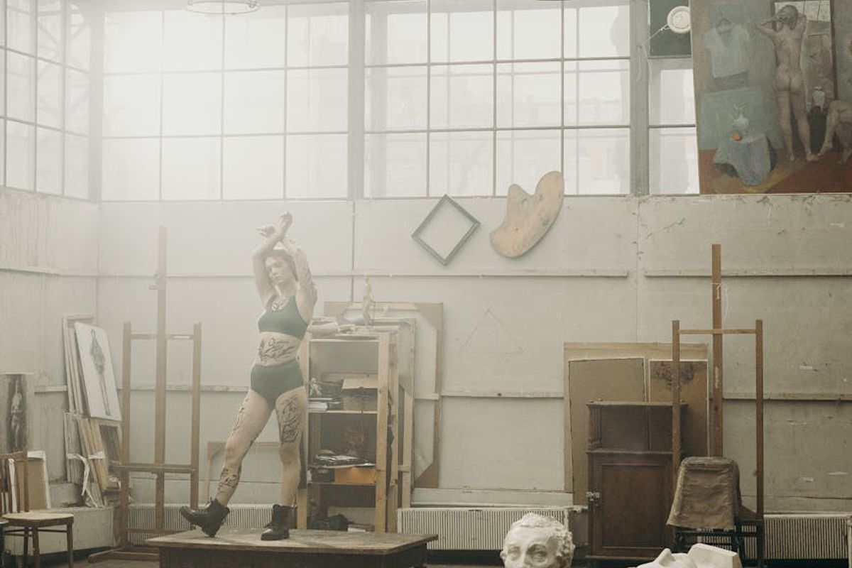 Spacious yoga studio with bamboo flooring and large windows.